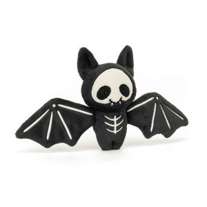 Front facing image of Jellycat Skelebat Jim. A small cuddly toy bat in black with Skellington embroidered bones, fangs and skull in super soft in charcoal grey fur and cream coloured suedette.